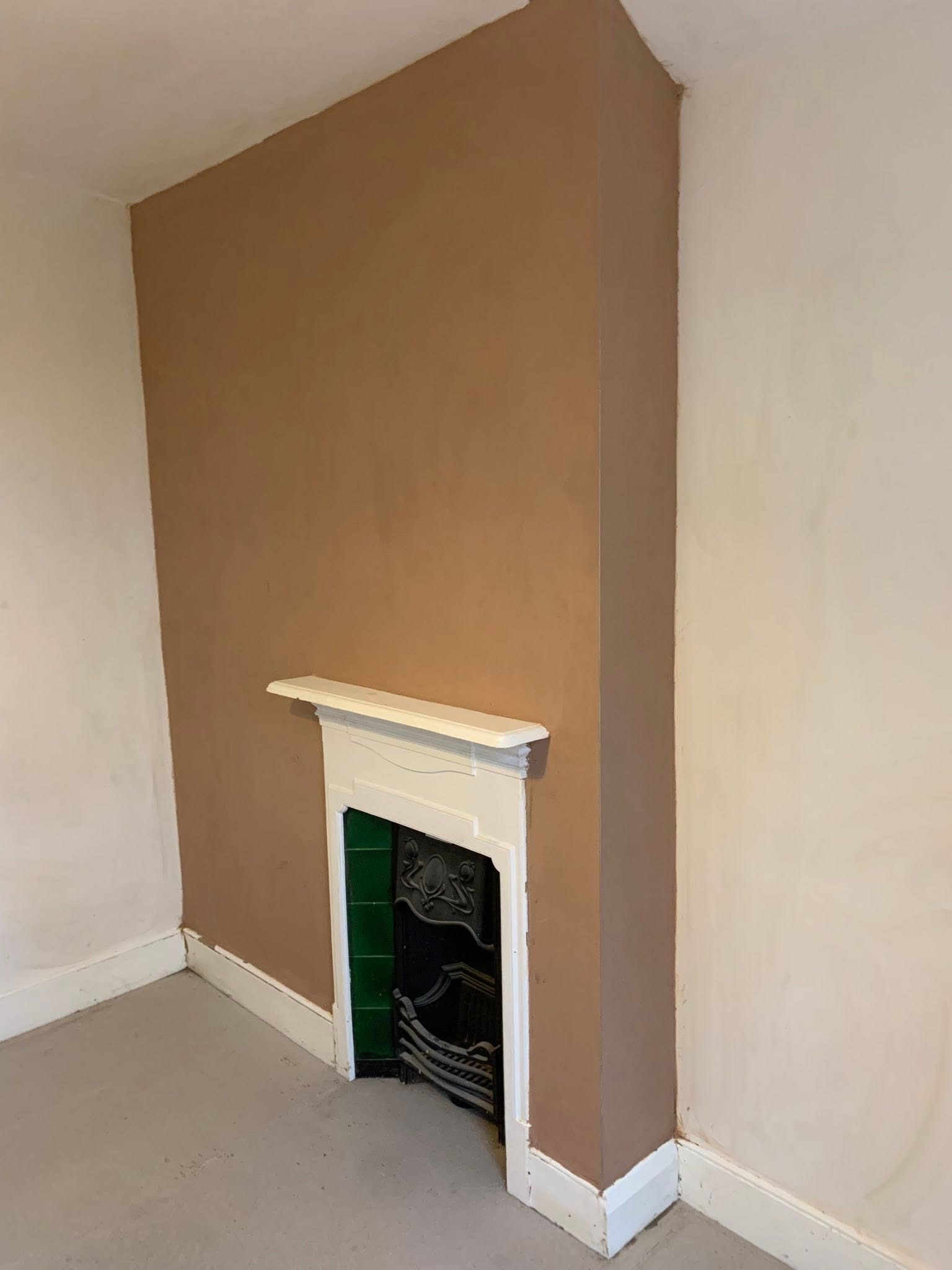 Chimney breast plastered and painted around the period fire surround