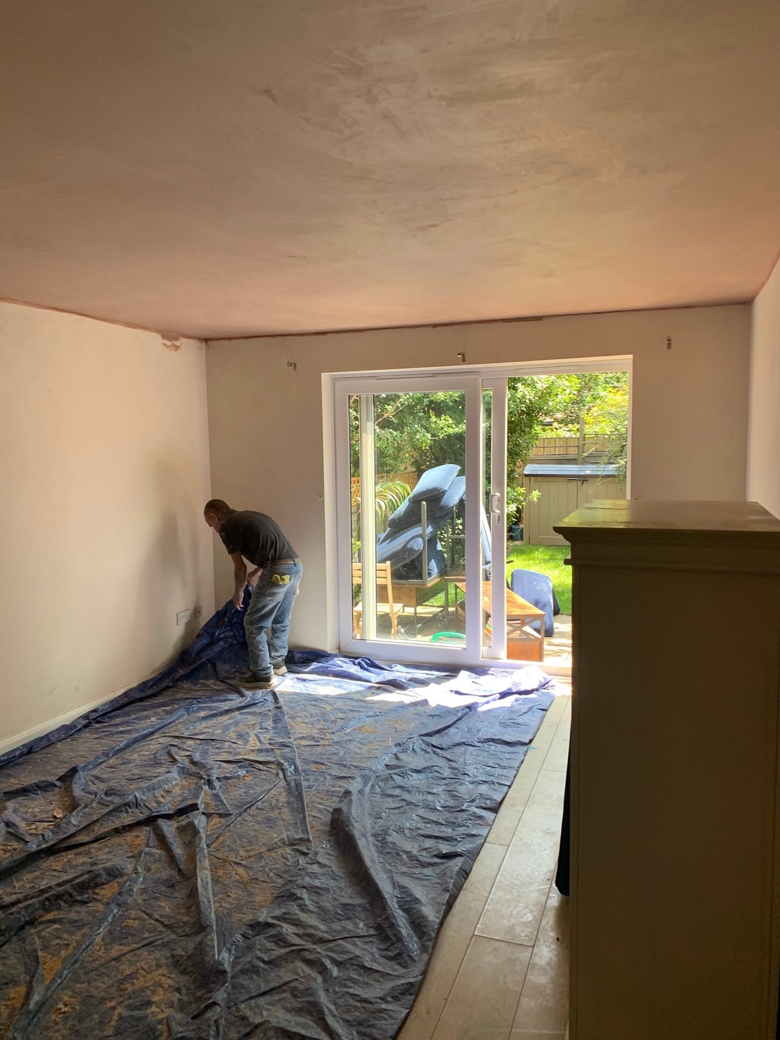 Room mid re-plaster with dust sheets down protecting the floor