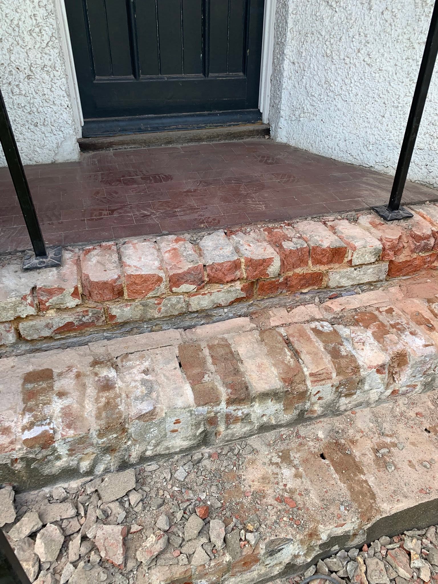 Worn brick front doorstep before repointing
